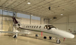 A small aircraft in an airplane hangar.