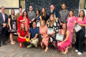 A group of people holding certificates.