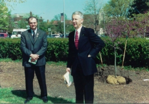 two people in suits standing outside