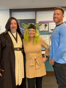 three people posing in costumes