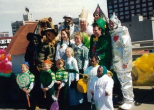 A group of people posing outside in costumes