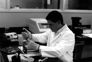 a grayscale photo of a person working in a lab