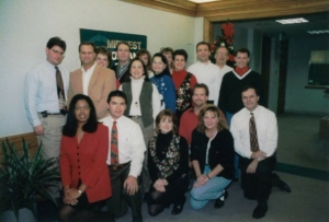 a group of people posing for a photo in an office