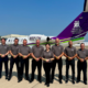 Pilots standing in formation in front of a plane owned by Midwest Transplant Network.