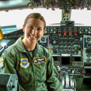 An Air Force pilot sitting in the cockpit of a military aircraft.