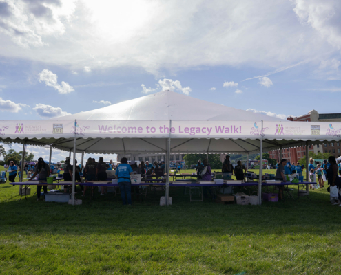 tent on a field that says Welcome to the Legacy Walk!