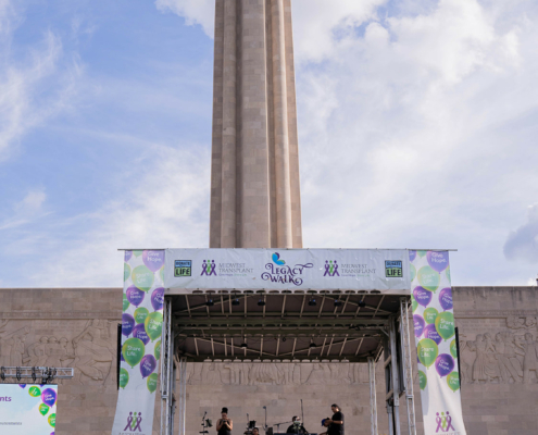 stage on a field with a building behind