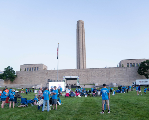 field with people and a building in the background