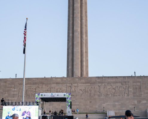 field with people and a building in the background