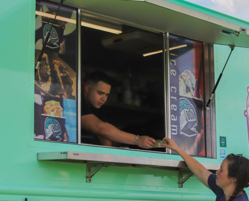 someone buying ice cream from an ice cream truck