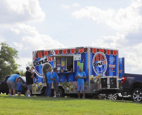 A food truck called DonutNV with people in front of it