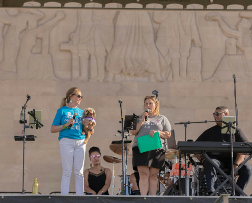 people on stage holding microphones