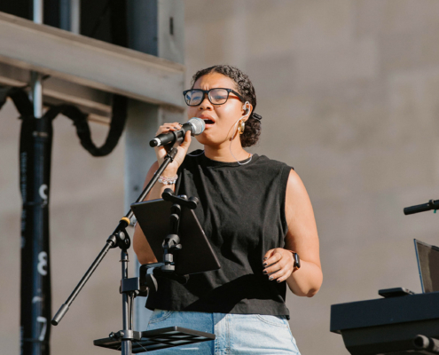 a person singing into a microphone on stage