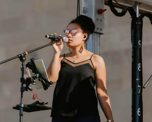 a person singing into a microphone on stage