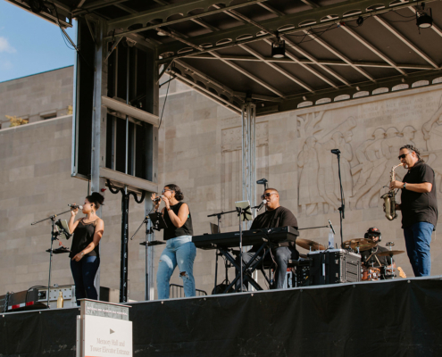 A band playing on an outdoor stage