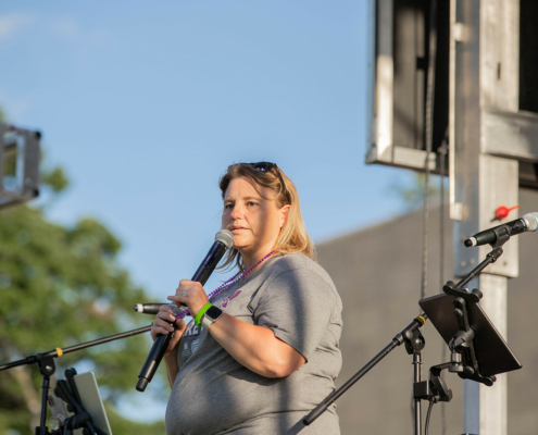 a person holding a microphone on stage