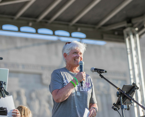 a person holding a microphone on stage