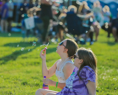 kids sitting in chairs and blowing bubbles