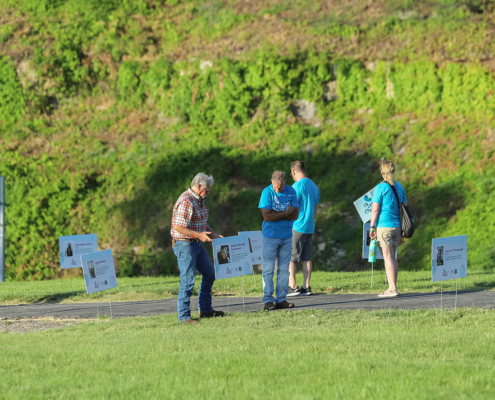 people looking at signs of donors outdoors