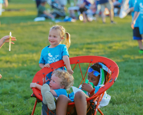 Kids sitting in a chair outdoors