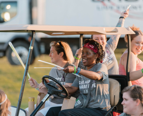 People riding in a golf cart