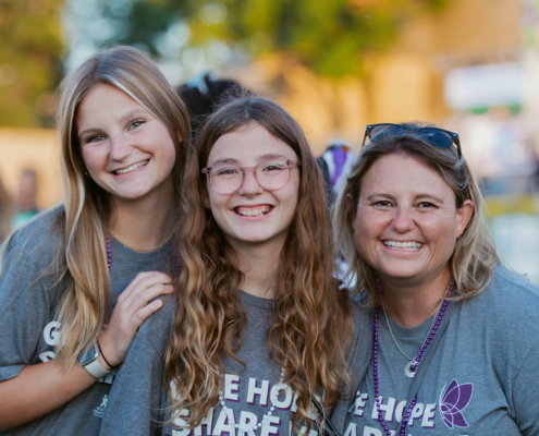 Three people smiling