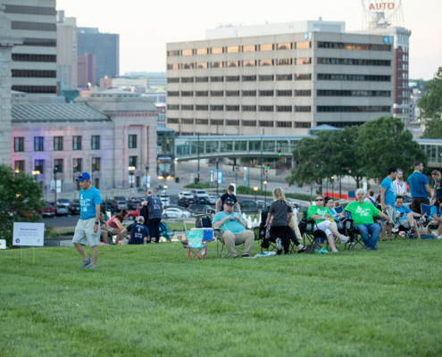 People sitting on chairs on a grass field